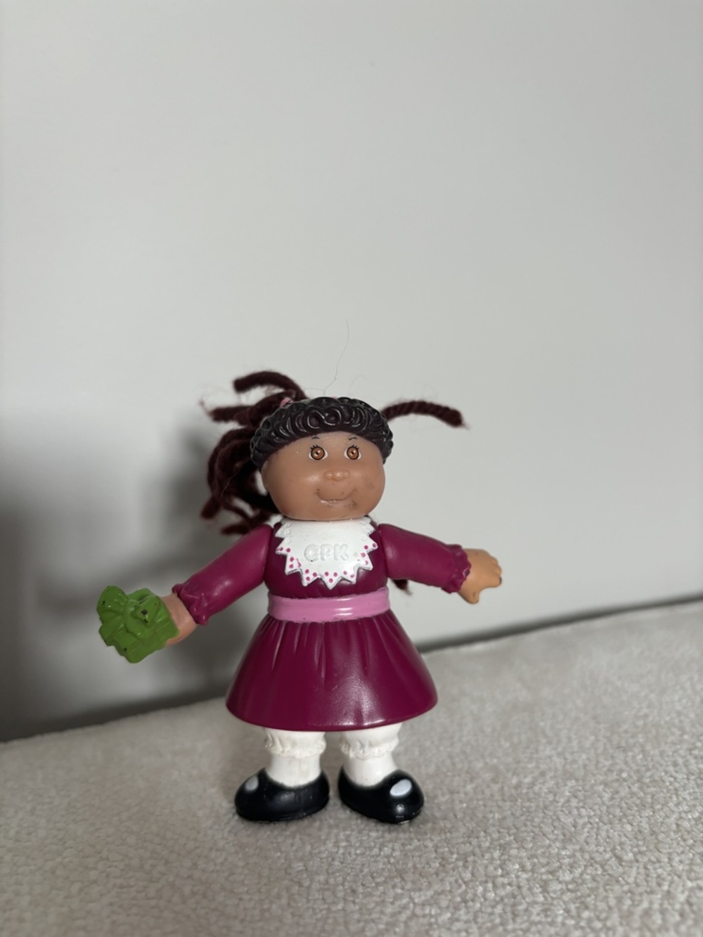 Cabbage patch kids figure with a present